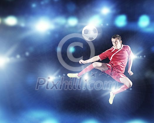 Young football player on stadium kicking ball Young football player on stadium kicking ball