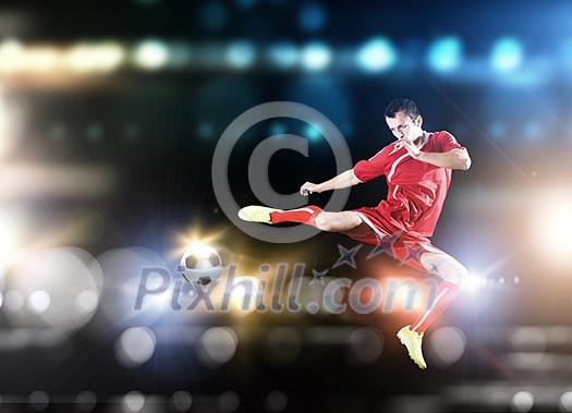 Young football player on stadium kicking ball Young football player on stadium kicking ball