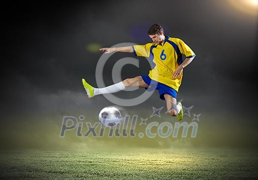 Young football player on stadium kicking ball Young football player on stadium kicking ball