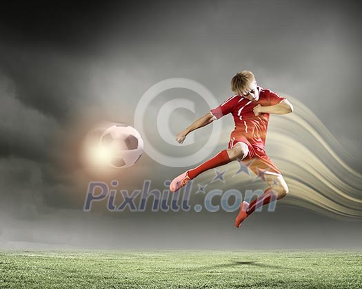 Young football player on stadium kicking ball Young football player on stadium kicking ball
