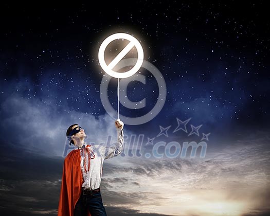 Young confident superman in mask and cape Young confident superman in mask and cape