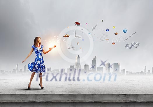 Young woman in blue dress reading book Young woman in blue dress reading book