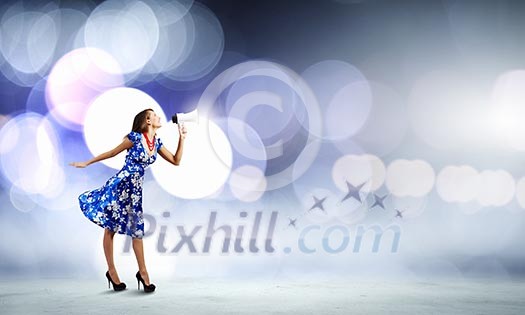 Young woman in blue dress talking in megaphone Young woman in blue dress talking in megaphone