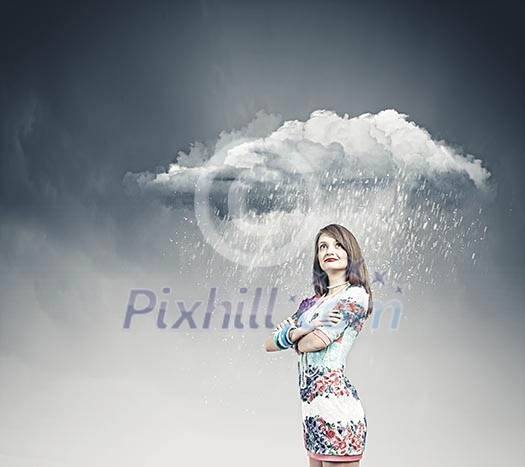 Young pretty woman standing under raining cloud