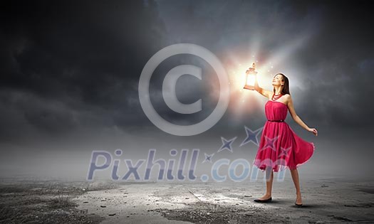 Young woman in red dress with lantern Young woman in red dress with lantern