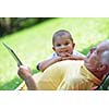 grandfather and child in park using tablet computer