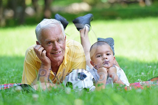 happy grandfather and child have fun and play in park happy grandfather and child have fun and play in park