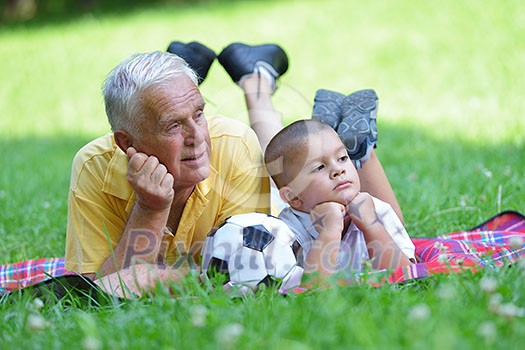 happy grandfather and child have fun and play in park happy grandfather and child have fun and play in park