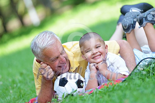 happy grandfather and child have fun and play in park happy grandfather and child have fun and play in park