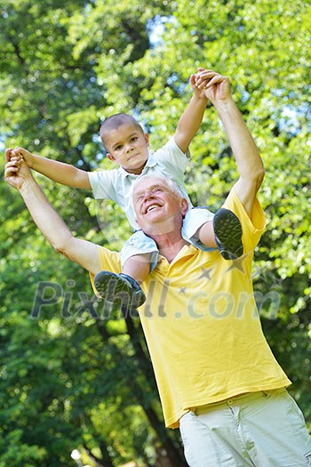 happy grandfather and child have fun and play in park happy grandfather and child have fun and play in park