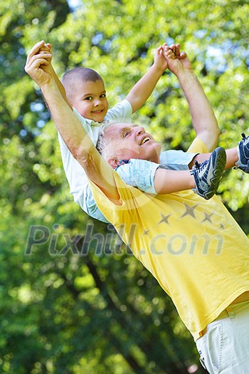 happy grandfather and child have fun and play in park happy grandfather and child have fun and play in park