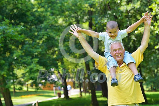 happy grandfather and child have fun and play in park happy grandfather and child have fun and play in park