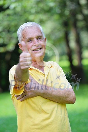 happy healthy and fit elderly man portrait in green background park happy healthy and fit elderly man portrait in green background park