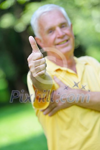 happy healthy and fit elderly man portrait in green background park happy healthy and fit elderly man portrait in green background park