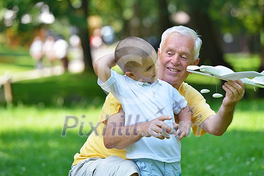 happy grandfather and child have fun and play in park happy grandfather and child have fun and play in park
