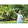 happy boy play and  throw airplane in park