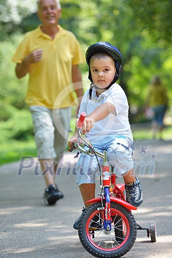 happy grandfather and child have fun and play in park happy grandfather and child have fun and play in park