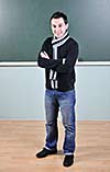 happy young student boy posing at university school classroom