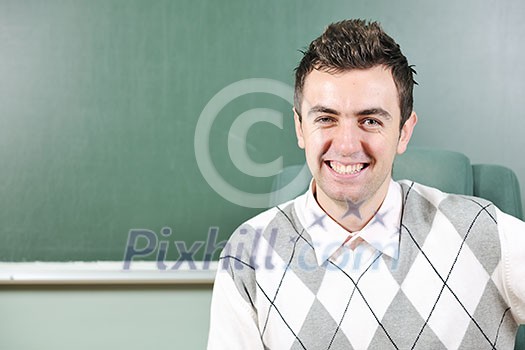 happy young student boy posing at university school classroom happy young student boy posing at university school classroom
