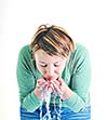 bautiful young woman wash face with clean water isolated on white in studio