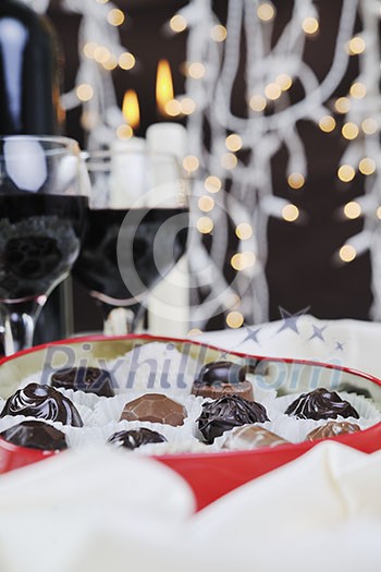luxury and sweet praline and chocolate with wine bottle and glasses decoration luxury and sweet praline and chocolate with wine bottle and glasses decoration