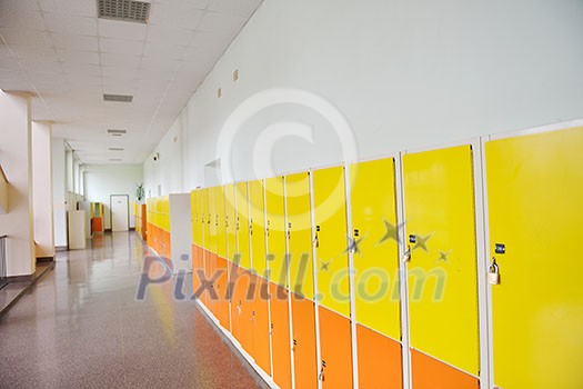 High School hallway showing yellow student lockers High School hallway showing yellow student lockers
