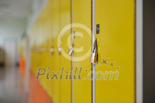 High School hallway showing yellow student lockers High School hallway showing yellow student lockers