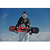 snowboarder relaxing and posing at sunny day on winter season with blue sky in background