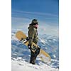 snowboarder relaxing and posing at sunny day on winter season with blue sky in background