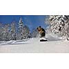 freestyle snowboarder jump and ride free style  at sunny winter day on mountain