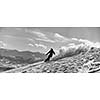 freestyle snowboarder jump and ride free style  at sunny winter day on mountain