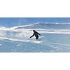 freestyle snowboarder jump and ride free style  at sunny winter day on mountain