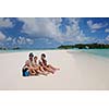 Portrait of a happy family on summer vacation  at beach
