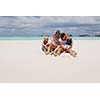 Portrait of a happy family on summer vacation  at beach