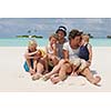 Portrait of a happy family on summer vacation  at beach