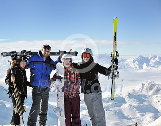 happy people group have fun on snow at winter season on mountain with blue sky and fresh air