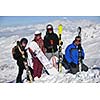 happy people group have fun on snow at winter season on mountain with blue sky and fresh air