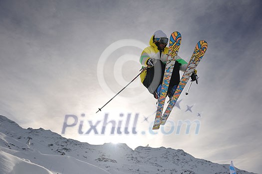 extreme freestyle ski jump with young man at mountain in snow park at winter season