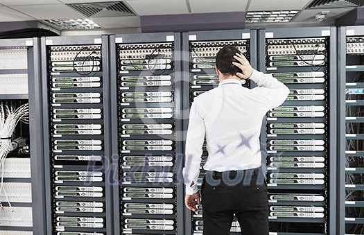 it business man in network server room have problems and looking for disaster situation solution it business man in network server room have problems and looking for disaster situation solution