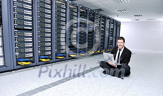 young engeneer business man with thin modern aluminium laptop in network server room young engeneer business man with thin modern aluminium laptop in network server room