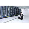 young engeneer business man with thin modern aluminium laptop in network server room