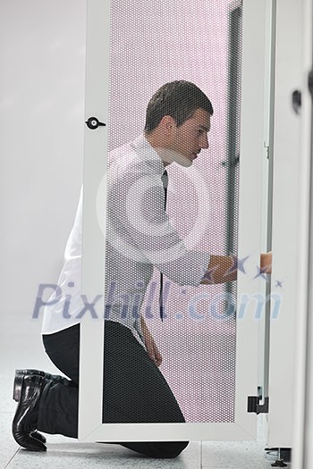young handsome business man engeneer in datacenter server room young handsome business man engeneer in datacenter server room
