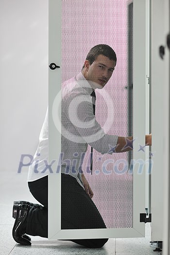 young handsome business man engeneer in datacenter server room young handsome business man engeneer in datacenter server room