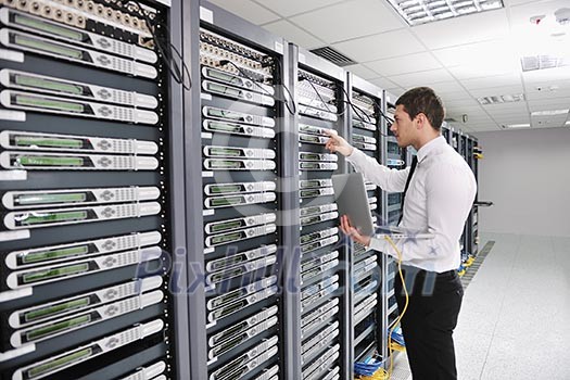 young handsome business man engeneer in datacenter server room young handsome business man engeneer in datacenter server room