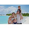 Portrait of a happy family on summer vacation  at beach
