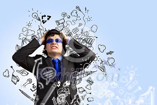 Image of depressed businessman tearing his hair Image of depressed businessman tearing his hair