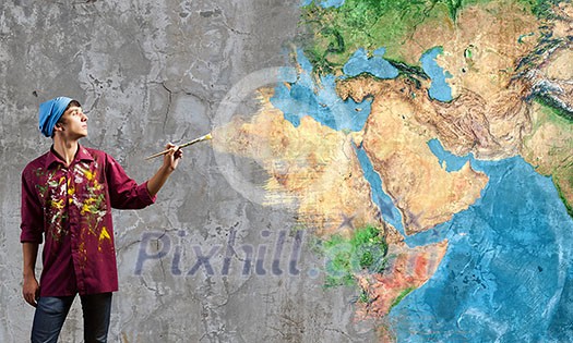 Young handsome man painter with brush in hand. Elements of this image are furnished by NASA Young handsome man painter with brush in hand. Elements of this image are furnished by NASA