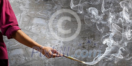 Young handsome man painter with brush in hand Young handsome man painter with brush in hand