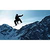 Snowboarder making jump high in clear sky