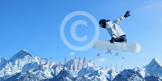 Snowboarder making jump high in clear sky Snowboarder making jump high in clear sky
